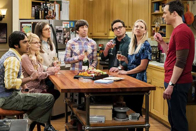The Big Bang Theory cast toasting in the kitchen